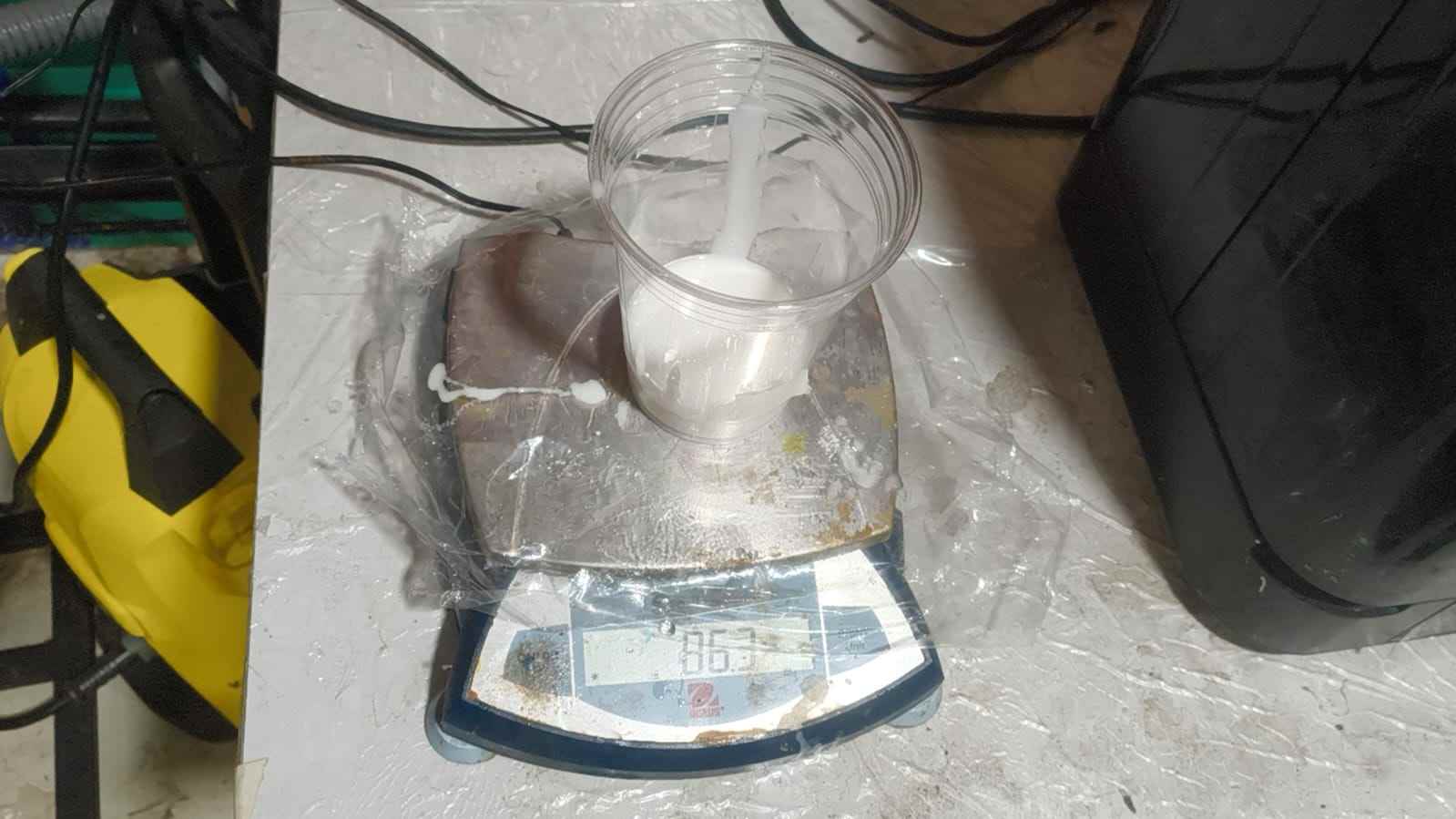 Two-part silicone components being weighed and mixed in preparation for casting