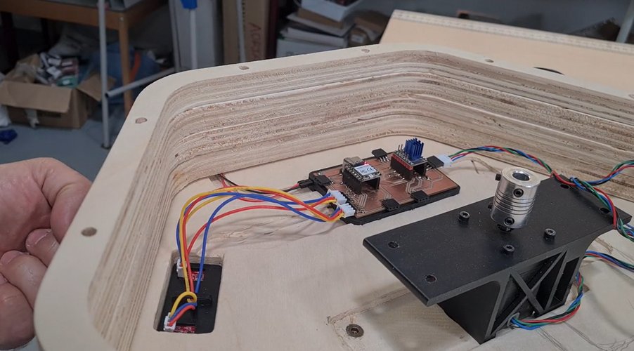 The CNC plywood base with the milled PCB, TMC2209 driver, touch sensors and motor mount wired in place