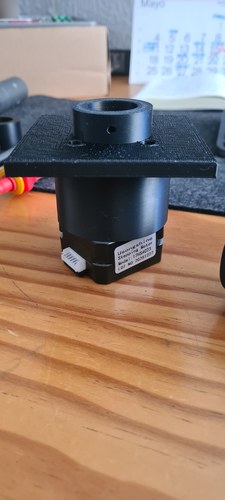 The Usongshine 17HS4023 NEMA 17 stepper seated in the printed motor mount, a square plate with a central collar.