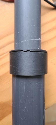 A grey PVC tube with a black printed PLA collar joining two bodies, the collar visibly cracked across the top from fit testing.