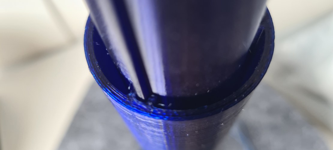 Close-up of the blue printed bodies nesting one inside the other, the internal guide ribs visible where the inner body meets the mid body.