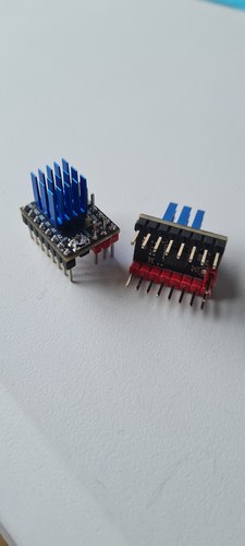 Two BigTreeTech TMC2209 v1.3 stepper driver modules, one upright with a blue heatsink and one flipped to show the TMC2209-LA chip and the red pin header.