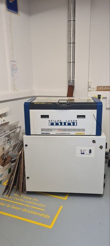 Epilog Laser Mini desktop CO2 laser cutter with its extraction duct at Fab Lab León.