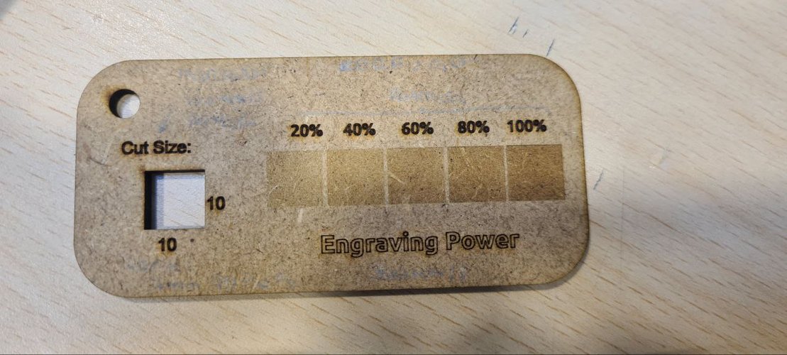 Laser test gauge engraving the same area at 20, 40, 60, 80 and 100 percent power, plus a cut-size slot.