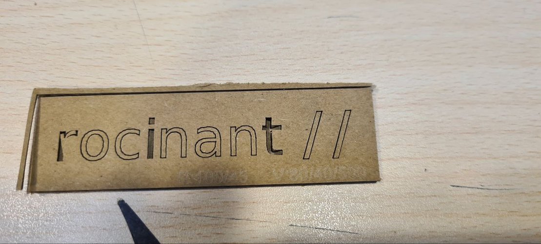 The rocinant // logo cut and engraved in cardboard on the Epilog.