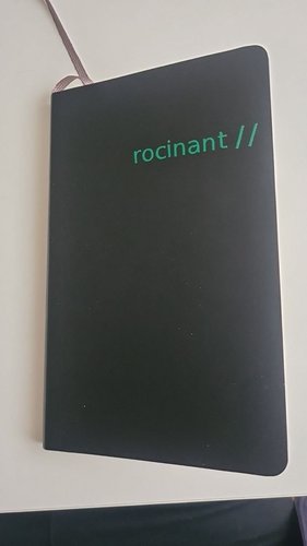 Green rocinant // outline letters applied on a black soft-cover Moleskine notebook.