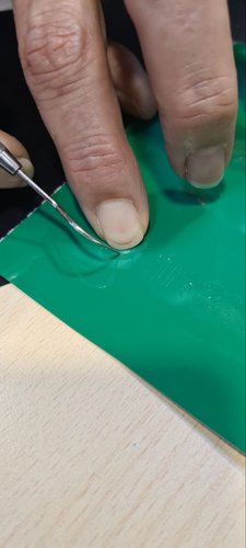 Lifting excess green vinyl with the weeding pick.