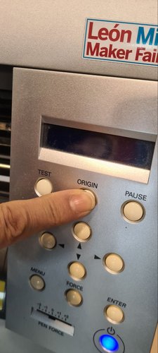 Pressing the ORIGIN button on the Roland GX-24 to set the cutting start point.