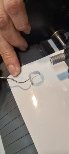 Lifting a small test shape from the white vinyl with a weeding pick.
