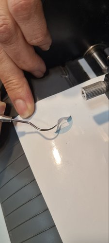 Weeding the fine details of the white vinyl sticker with the pick.
