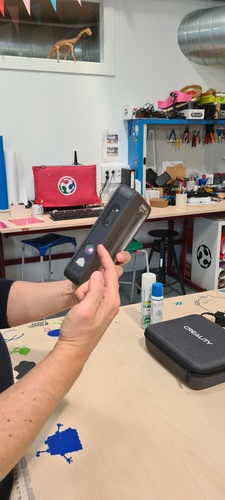 Holding the 3D Sense scanner during a scanning session.