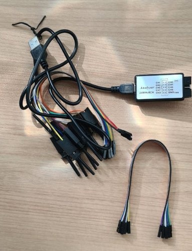 USB logic analyzer with 8 channels, cables, and Dupont jumper wires.