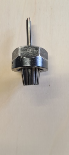 The 6 mm end mill assembled inside the collet and nut, ready to be threaded onto the spindle.