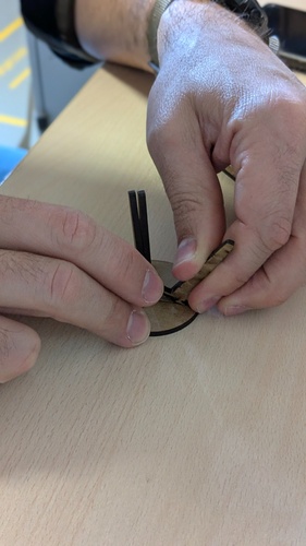 Two small laser-cut MDF pieces for the stool prototype: one with a T-shaped profile and one with a rectangular slot, both in black 3 mm MDF.