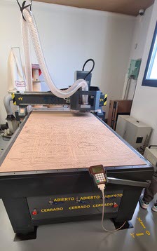 Full frontal view of the TEC-CAM 500 CNC router with the martyr board on the table and the RichAuto A11 controller hanging from the front.