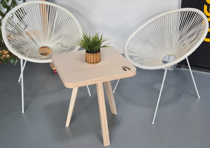 The finished tea table centred between two white chairs.