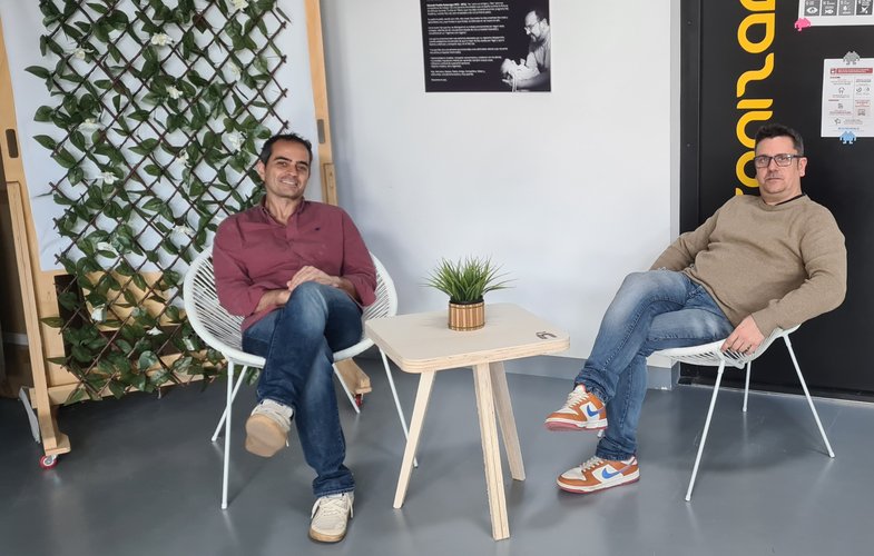 Pablo and myself sitting on chairs either side of the tea table, enjoying the end result.