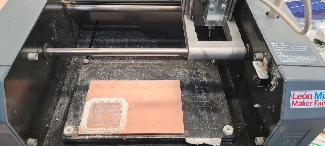 Milled PCB and spatula on cutting mat, traces clearly visible, board outline cleanly cut.