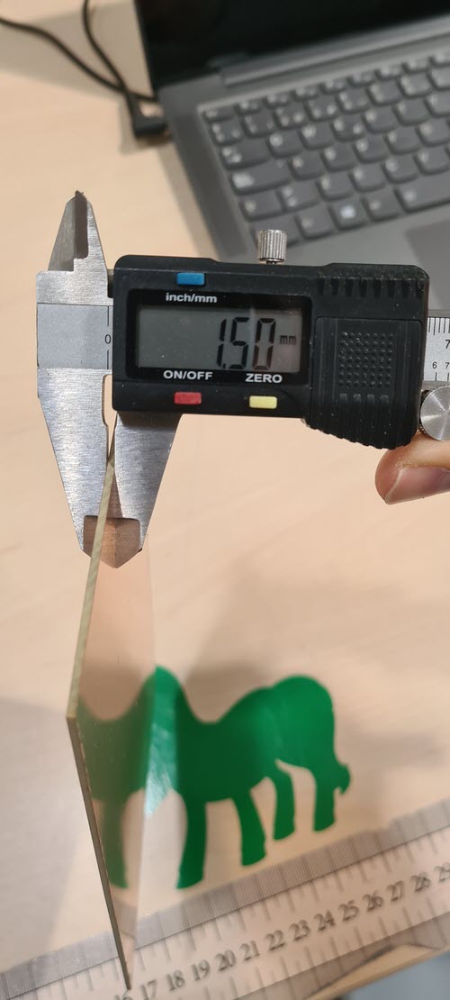 Digital caliper measuring FR1 board thickness reading 1.50 mm.