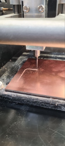 Roland MDX-20 milling in progress, side view, spindle over copper-clad board.