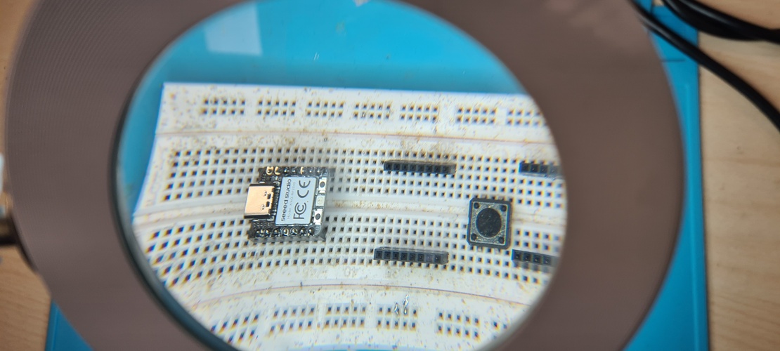 Close-up of milled PCB in PCB vise showing trace detail and board outline.