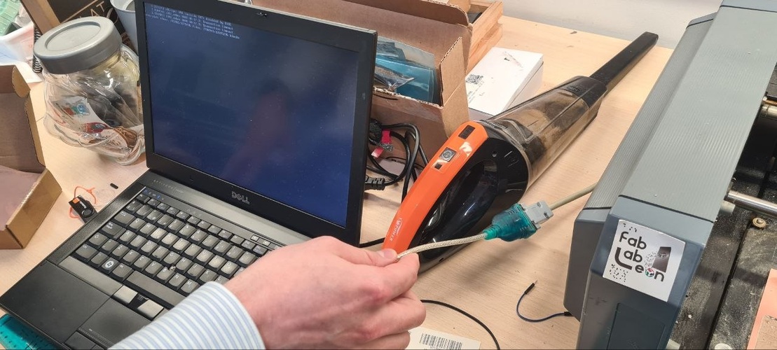 Dell laptop connected to Roland MDX-20 via RS-232 to USB adapter cable, terminal window visible on screen.