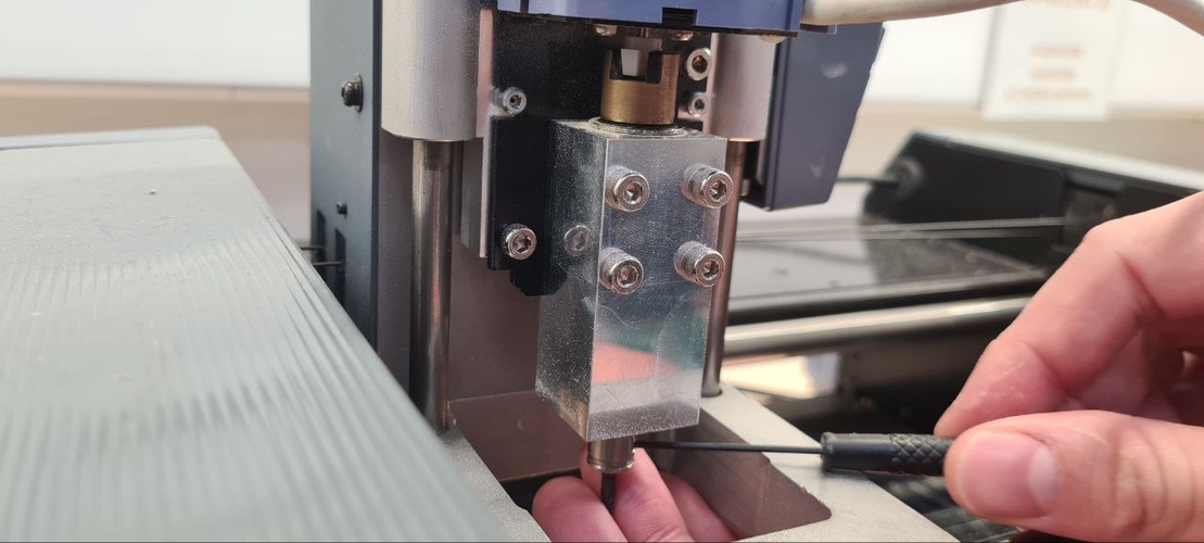 Hand inserting end mill into MDX-20 collet during tool change procedure.