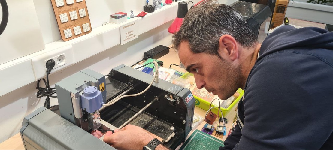 Close-up of Roland MDX-20 spindle showing two set screws on the collet and the end mill tip.