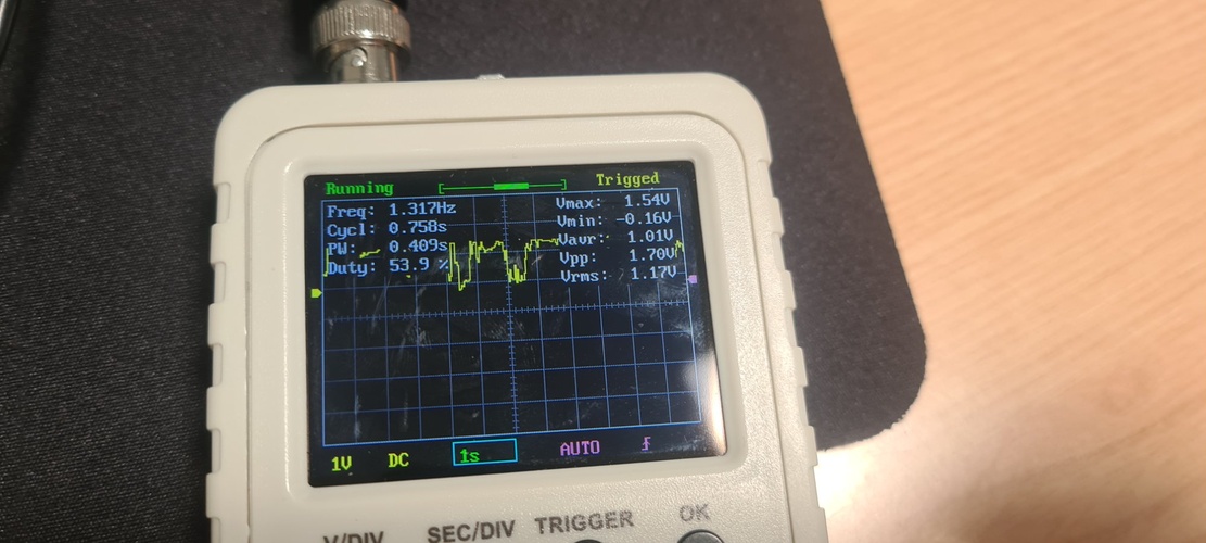 DSO Shell at 1 s per division showing the Hall effect sensor analog output varying as a magnet is moved toward and away from the sensor, with Freq 1.317 Hz, Vmax 1.54 V and Vpp 1.70 V.