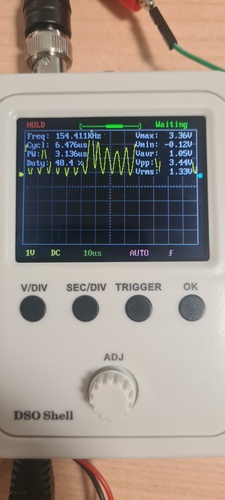 DSO Shell in HOLD mode showing SCL clock pulses frozen, with Freq 154 kHz, Vmax 3.36 V and Vpp 3.44 V — consistent with the Running capture.