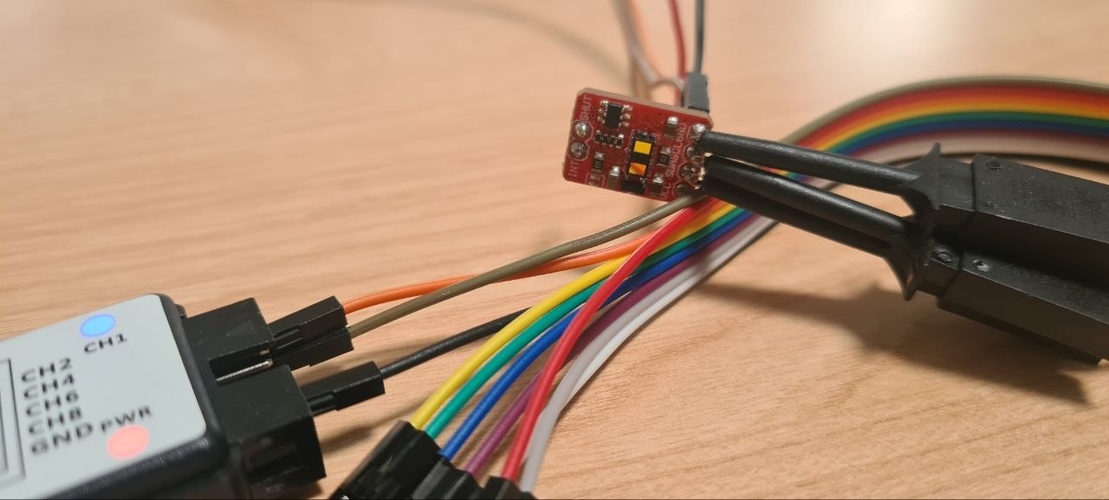 Close-up of the logic analyzer probes clipped onto the VL53LXX breakout module header pins.