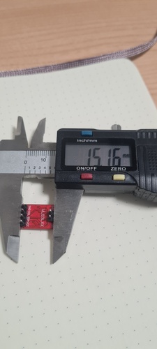Digital caliper measuring the width of the VL53LXX breakout module pin group showing 15.16 mm total exterior width across all six pins.