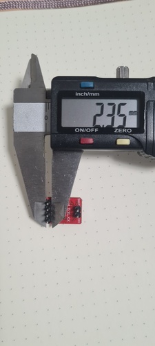 Digital caliper measuring the width of the SHUT and INT pin group on the VL53LXX breakout showing 2.35 mm.