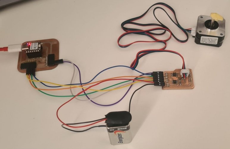The soldered A4950 driver board on the bench, wired through its J2 header to the XIAO RP2040 Week 08 board, to the Usongshine 17HS4023 NEMA 17 stepper motor, and to a 9 V battery for the motor supply.