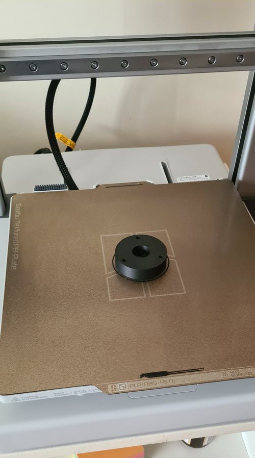 Single part centered on the A1 textured PEI plate during a calibration print.