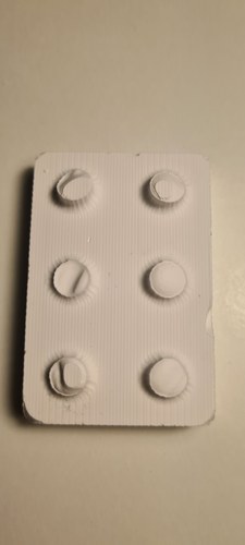 Plaster cast from the wax-milled master (Track A): a white 2x3 brick face covered in fine parallel milling lines, with toolpath marks radiating around each stud. Several studs are incomplete, short or torn at the tip from trapped air.