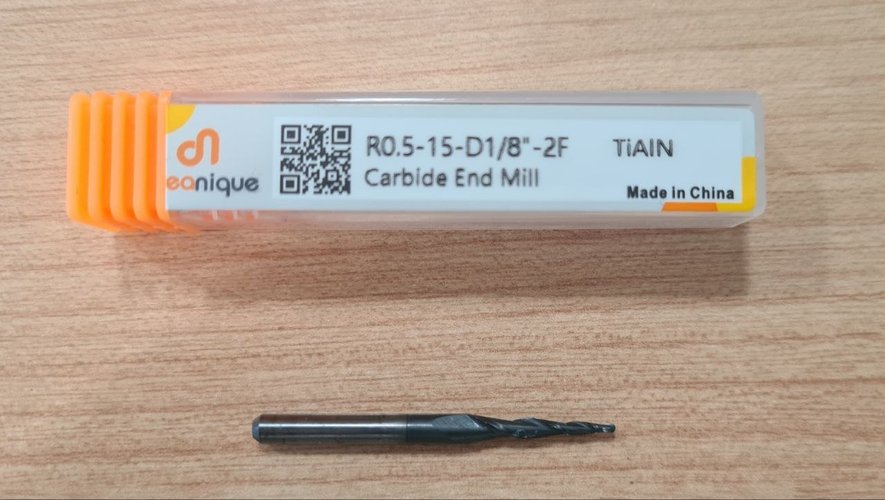Dreanique tapered ball-nose endmill in its plastic case, with the marking R0.5-15-D1/8\