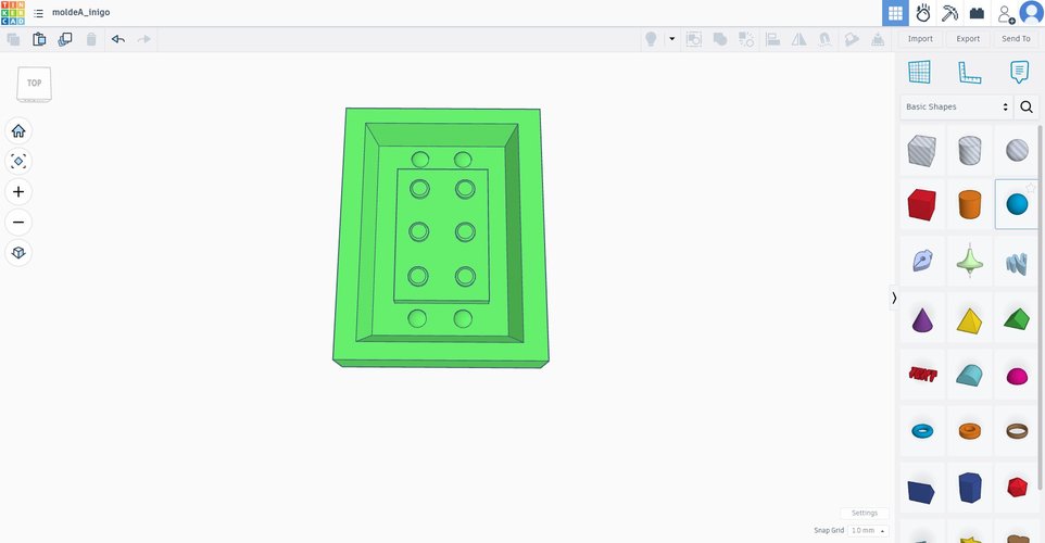 Top view of the finished mould half rendered as a solid in Tinkercad. The brick cavity is recessed into the central area, with the six stud cavities and the two peg holes on the bottom edge clearly visible.