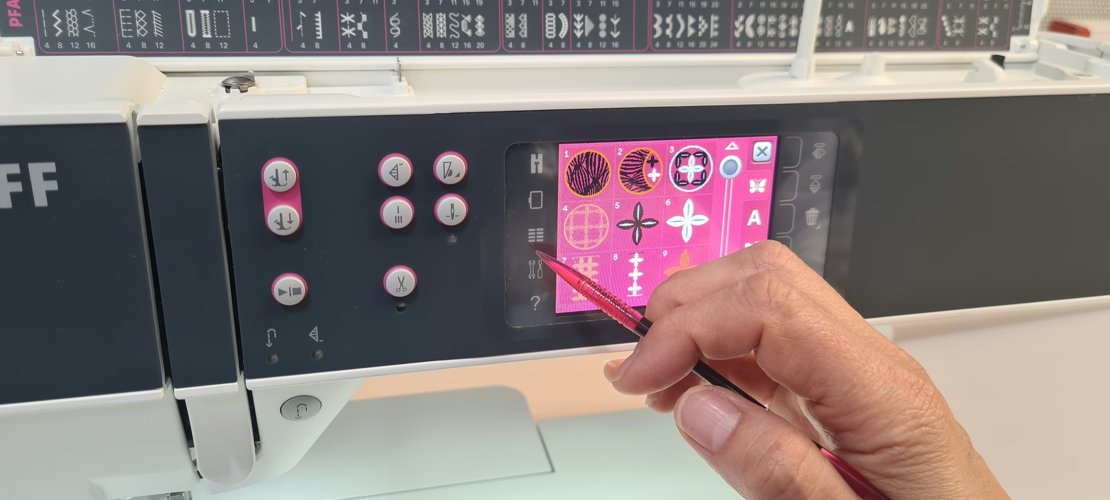 Machine screen showing the built-in embroidery design library: a numbered grid of decorative motifs.