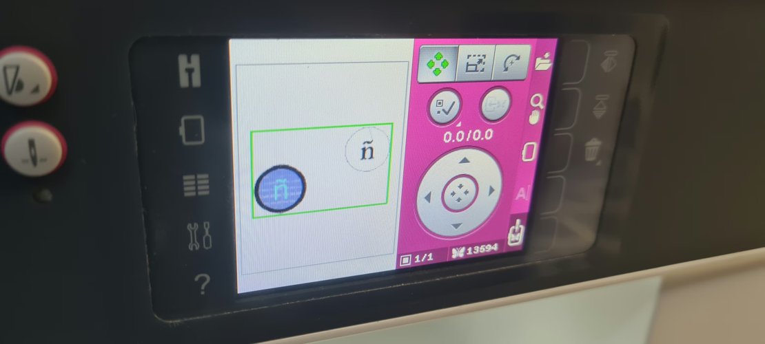 Machine preview showing two elements: the loaded design and a stray ñ outside the hoop frame.