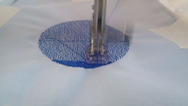 CNC embroidery machine producing the captain symbol