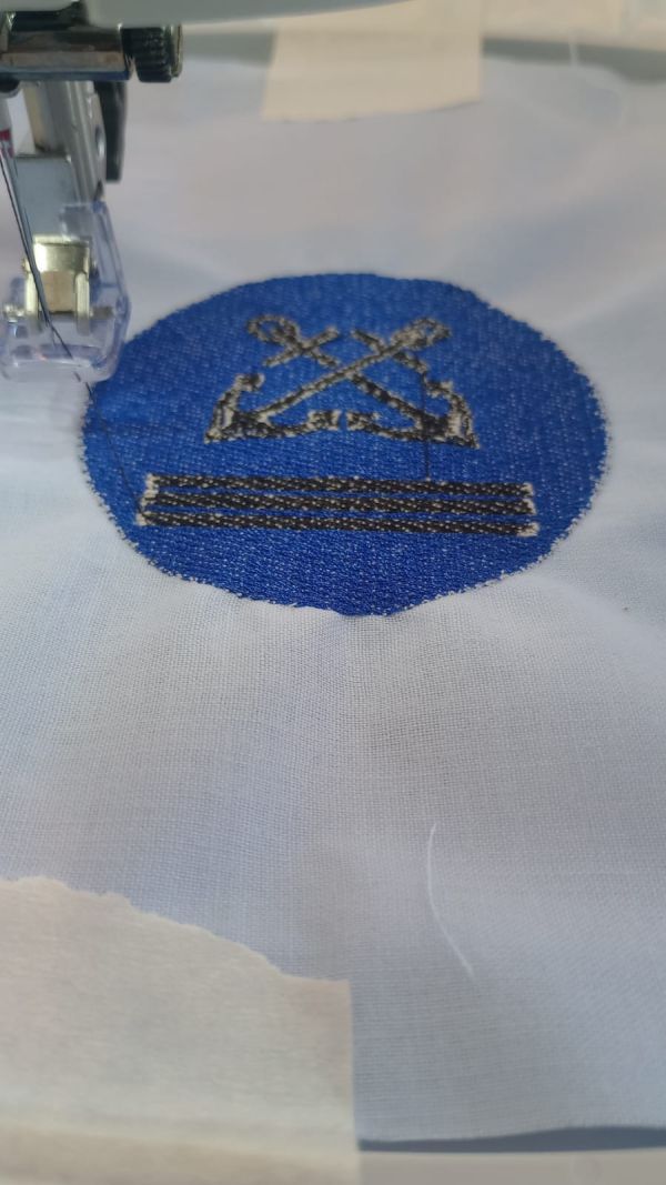 CNC embroidery machine producing the captain symbol