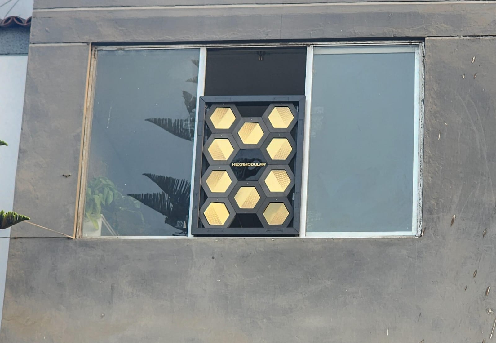 HEXAMODULAR panel installed within a residential window frame