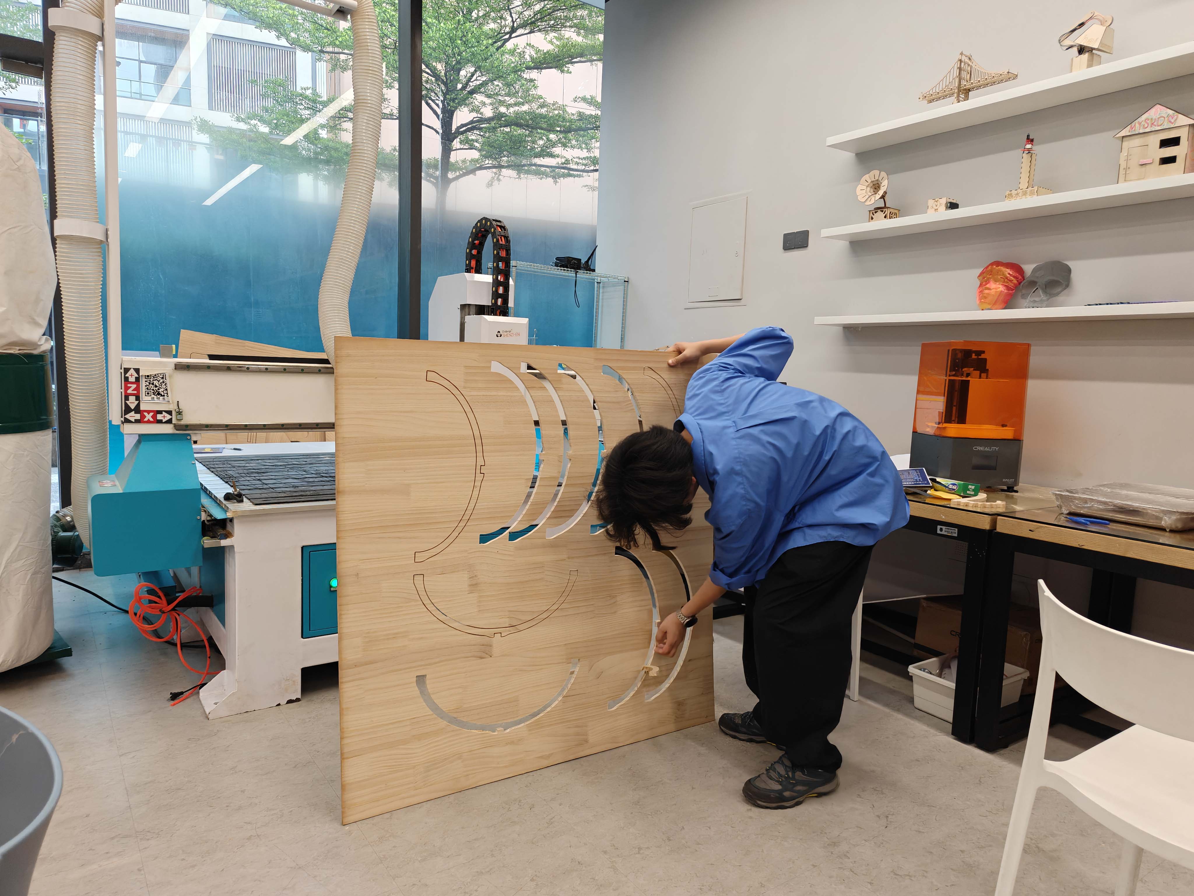 Removing CNC-cut chair parts from the wooden sheet