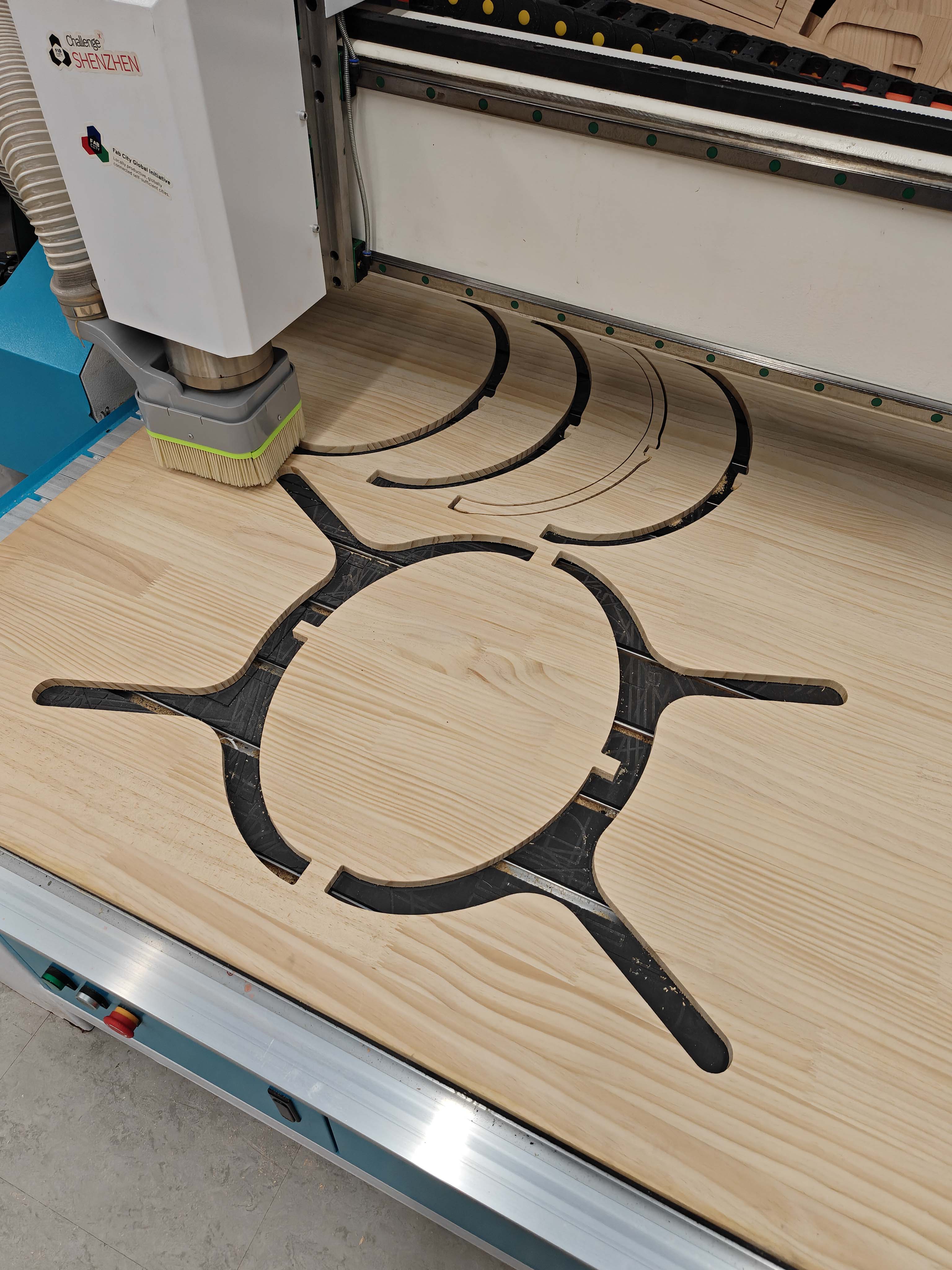 CNC-cut chair parts still on the machine bed after cutting