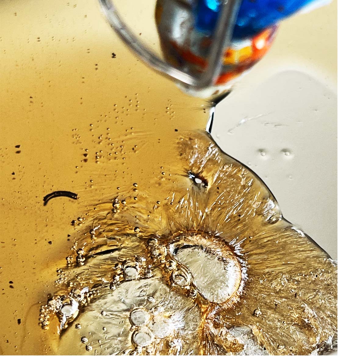 Close-up of bubbles and amber bio-material surface