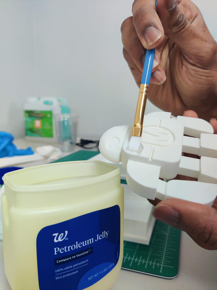 Brushing petroleum jelly onto the robot positive as a release agent