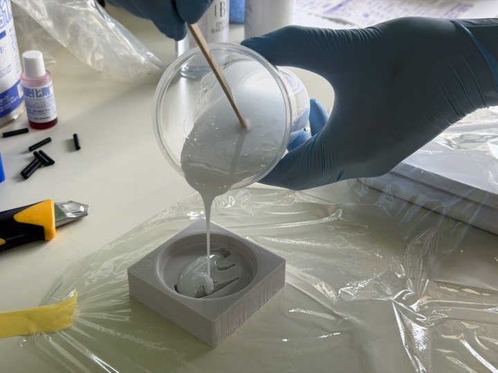 Pouring resin into silicone mold