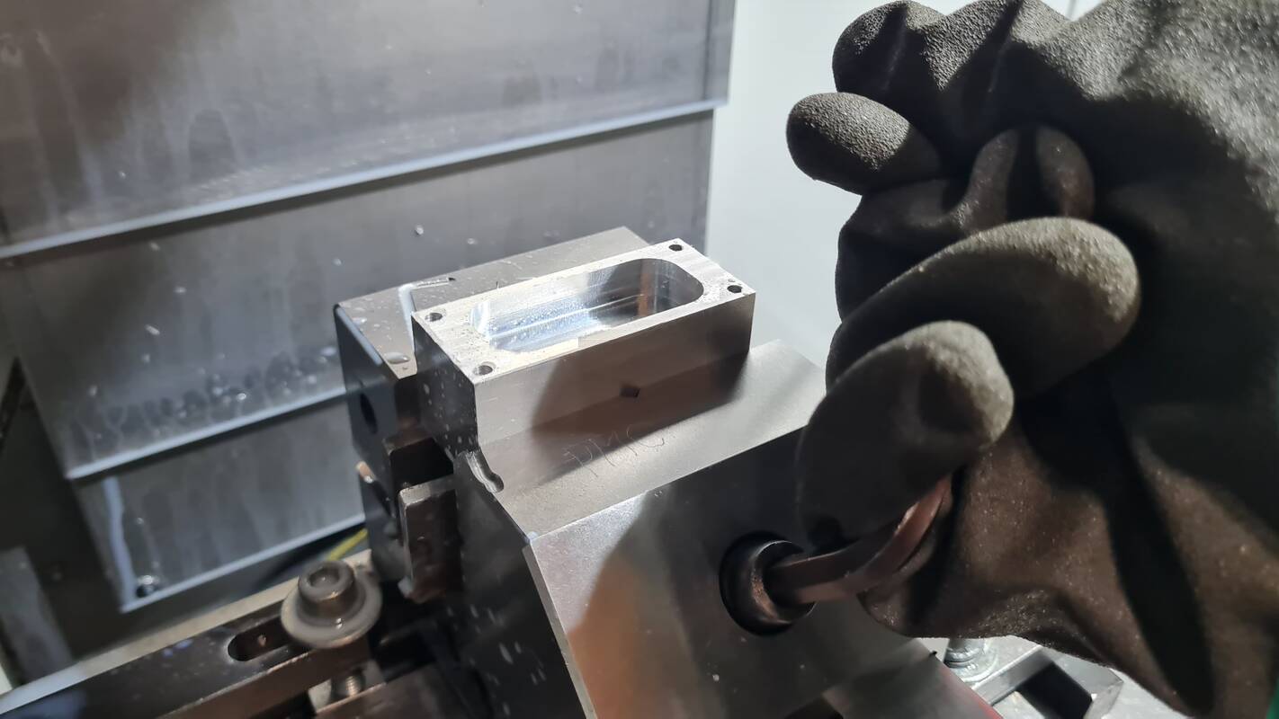 Taking the machined part out of vise after clean up.