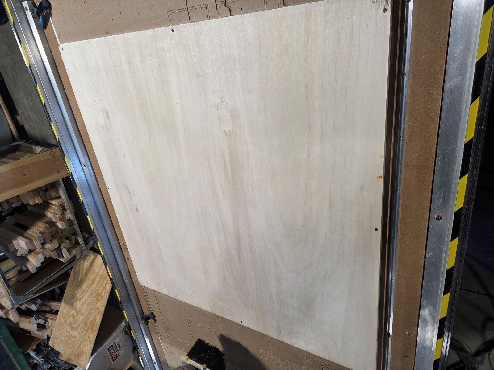 Plywood screwed down to the CNC table